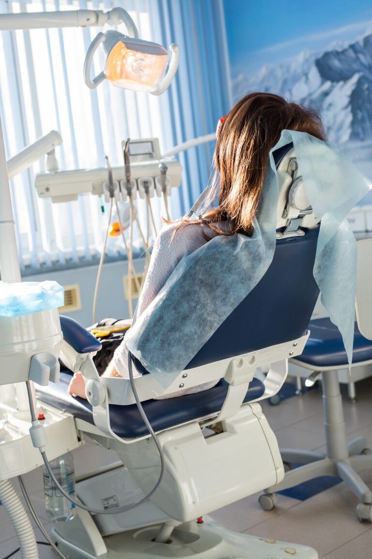 Patient sitting on dental chair, waiting for her dentist